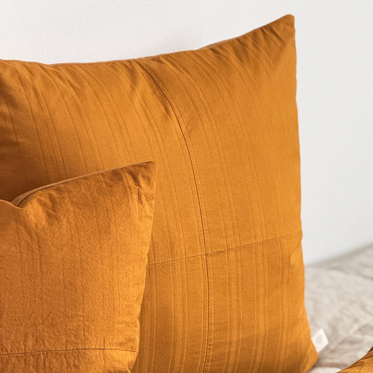 Set of two upcycled cushions, burnt orange stripes, feather inners included