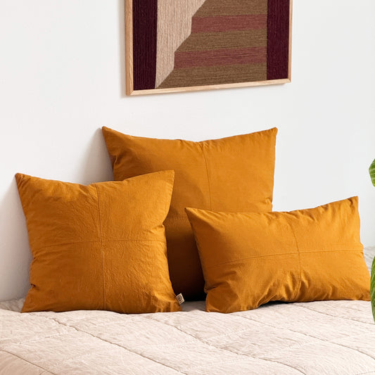 Set of three upcycled cushions, burnt orange, feather inners included